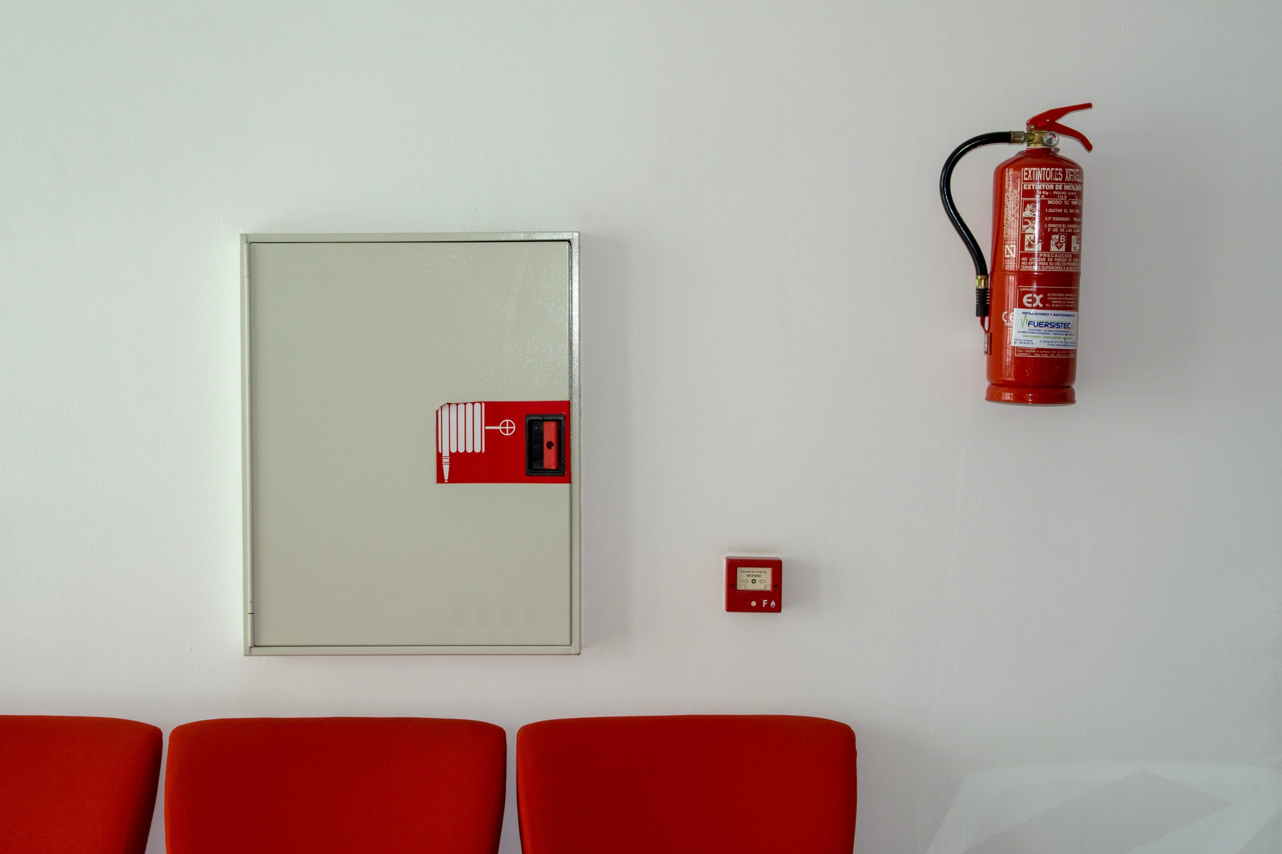 Imagen de zona de espera con alarma contra incendios y extintor
